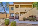 Tan condo building featuring private entrances, landscaped grounds, and a well-maintained exterior at 2134 E Broadway Rd # 2033, Tempe, AZ 85282