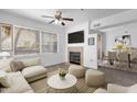 Cozy living room featuring a ceiling fan, fireplace, plush seating, and plenty of natural light at 2134 E Broadway Rd # 2033, Tempe, AZ 85282