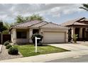 Charming single-story home featuring a well-manicured lawn, tile roof, and an attached two-car garage at 2865 E Cathy Dr, Gilbert, AZ 85296