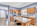 Well-equipped kitchen with stainless steel appliances, a center island, and ample counter space at 2865 E Cathy Dr, Gilbert, AZ 85296