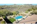 Aerial shot of backyard oasis with pool, patio, and lush landscaping showcasing the property's outdoor features at 30696 N 130Th Ln, Peoria, AZ 85383