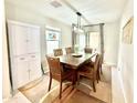 Dining room with a rustic wooden table, leather chairs, and a built-in hutch at 3937 S 79Th Ln, Phoenix, AZ 85043