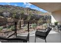 This home has a beautiful patio with chairs and a view of the surrounding mountains at 5000 N Camelback Ridge Dr # 107, Scottsdale, AZ 85251