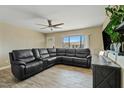 Spacious living room featuring a large sectional sofa and wood-look floors at 730 W El Alba Way, Chandler, AZ 85225