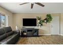 Living room with dark brown media console and large TV at 730 W El Alba Way, Chandler, AZ 85225