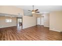 Spacious living area with wood floors, vaulted ceiling, neutral paint, and lots of natural light at 7331 W Aster Dr, Peoria, AZ 85381