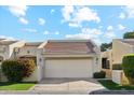 Attractive front exterior of home with a two-car garage and landscaping at 7359 E Valley View Rd, Scottsdale, AZ 85250