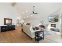 Open concept living room with hardwood floors, vaulted ceilings and fireplace at 7359 E Valley View Rd, Scottsdale, AZ 85250