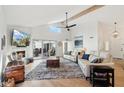 Spacious living room featuring hardwood floors, fireplace and access to patio at 7359 E Valley View Rd, Scottsdale, AZ 85250