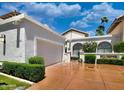 Gorgeous home featuring a two-car garage, decorative plants, and a driveway at 10120 E Topaz Dr, Scottsdale, AZ 85258