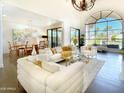 Bright and airy living room with large windows and comfortable, stylish seating at 10120 E Topaz Dr, Scottsdale, AZ 85258