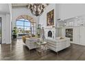 Bright living room with a fireplace, large windows, and wood flooring at 10120 E Topaz Dr, Scottsdale, AZ 85258