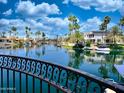 Waterfront view from balcony featuring palm trees, calm water, and neighborhood at 10120 E Topaz Dr, Scottsdale, AZ 85258
