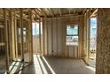 A framed room with window showing the stud and sheeting in an unfinished home under construction at 11441 E Utopia Ave, Mesa, AZ 85212