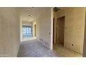 Bright hallway featuring neutral walls and doorways leading to various rooms, ready for new flooring at 11441 E Utopia Ave, Mesa, AZ 85212