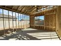 Spacious unfinished room with framed walls, a large window, and a smooth concrete floor in new home at 11441 E Utopia Ave, Mesa, AZ 85212