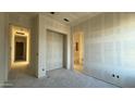 A versatile room with multiple doorways and light-colored walls, ready to be transformed into a bedroom or office at 11441 E Utopia Ave, Mesa, AZ 85212