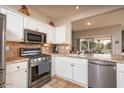 Spacious kitchen with stainless steel appliances and granite countertops at 16043 W Copper Crest Ln, Surprise, AZ 85374