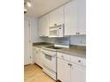 White kitchen cabinets, new appliances and countertops at 1701 E Colter St # 421, Phoenix, AZ 85016