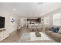 Inviting living area with a modern kitchen, dining space, and comfortable seating arrangement at 18819 W Cholla St, Surprise, AZ 85388