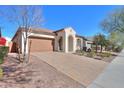 Attractive single-story home with a paved driveway and well-manicured landscaping at 20508 W Carlton Mnr Mnr, Buckeye, AZ 85396