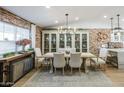 Bright dining room featuring a rustic table and exposed brick accent wall at 2111 W Mulberry Dr, Phoenix, AZ 85015