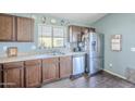 Modern kitchen featuring stainless steel appliances and wood cabinetry at 24191 N Desert Dr, Florence, AZ 85132