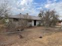 House with a large front yard and mature trees at 2613 E Lynne Ln, Phoenix, AZ 85042