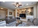 Spacious living room featuring a built-in entertainment center and fireplace at 26293 W Sierra Pinta Dr, Buckeye, AZ 85396