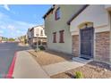 Front entrance of townhome with stone accents and security door at 2725 E Mine Creek Rd # 2054, Phoenix, AZ 85024