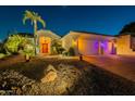 Night view of the home showcasing the well-lit landscaping and garage at 2741 E Claire Dr, Phoenix, AZ 85032