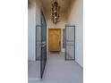 Elegant entryway with ornate chandelier and a wood door at 2741 E Claire Dr, Phoenix, AZ 85032