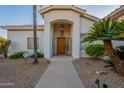 Inviting front entry with decorative wrought iron gate and a wood door at 2741 E Claire Dr, Phoenix, AZ 85032