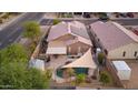 Aerial view of a private backyard with a swimming pool, patio seating, and desert landscaping at 3102 W Louise Dr, Phoenix, AZ 85027