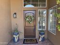 Inviting entryway with a decorative wreath and potted plants at 4330 N Ranier Cir, Mesa, AZ 85215