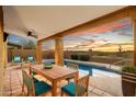 Relaxing patio area with a pool and stunning sunset view at 4330 N Ranier Cir, Mesa, AZ 85215