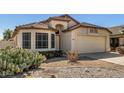 Charming single-story home with desert landscaping, a front-facing garage and neutral color scheme at 4383 E Coal St, San Tan Valley, AZ 85143