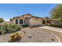 Attractive home featuring well-maintained desert landscaping and a two-car garage with light beige exterior at 4383 E Coal St, San Tan Valley, AZ 85143