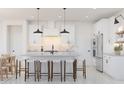 Modern kitchen with white cabinets, island, stainless steel appliances, and farmhouse sink at 4388 N 203Rd Dr, Buckeye, AZ 85396