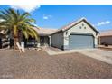 Charming single-story home featuring a low maintenance front yard, mature palm tree, and two-car garage at 480 E Bart Dr, Chandler, AZ 85225