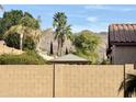 View of the backyard featuring desert landscaping, block wall and shade structure at 5612 W Alyssa Ln, Phoenix, AZ 85083