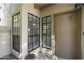 Welcoming front entry with a stylish front door, well-placed windows, and a decorative potted plant at 9705 E Mountain View Rd # 1050, Scottsdale, AZ 85258