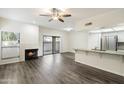 Bright living room featuring a cozy fireplace, modern flooring, and sliding glass doors for natural light at 9705 E Mountain View Rd # 1050, Scottsdale, AZ 85258