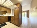 Kitchen features wood cabinets, tile floor, and modern appliances at 10330 W Thunderbird Blvd # A304, Sun City, AZ 85351