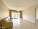 Bright living room with tile floors and access to balcony at 10330 W Thunderbird Blvd # A304, Sun City, AZ 85351