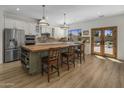 Spacious kitchen featuring an island with butcher block countertop and stainless steel appliances at 10685 E Cinnabar Ave, Scottsdale, AZ 85258