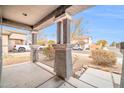 Covered front porch with stone pillars and wrought-iron railing at 11004 N 154Th Ln, Surprise, AZ 85379