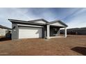 Single-story home with a two-car garage, covered entry, and minimal landscaping at 11438 E Utopia Ave, Mesa, AZ 85212