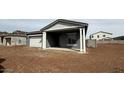 View of a single-story home with a covered entryway, attached garage and desert landscaping at 11438 E Utopia Ave, Mesa, AZ 85212