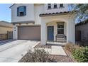 Two-story home's inviting front entrance with a gray door and bench at 13184 N 144Th Ln, Surprise, AZ 85379